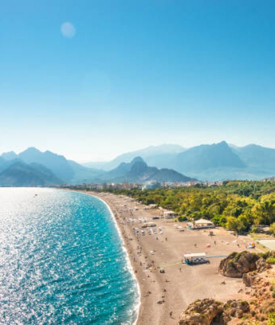 Panoramic bird view of Antalya and Mediterranean seacoast and beach with a paraglider, Antalya, Turkey, Autumn